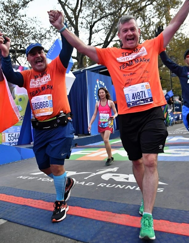 Tom and Mark crossing the finish line 2019